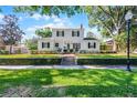 Beautiful white two-story home with black shutters and a manicured lawn at 1106 Ayrshire St, Orlando, FL 32803