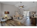 Spacious living room with vaulted ceilings, ceiling fan, and stylish decor at 1124 Shadowbrook Trl, Winter Springs, FL 32708