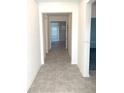 Bright hallway with gray tile floors leading into other rooms of the home at 1374 Brentwood Dr, Kissimmee, FL 34746