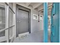 Inviting condo entrance featuring a gray door, stylish hardware, and a charming welcome mat at 151 N Orlando Ave # 115, Winter Park, FL 32789