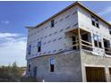 Construction of a townhome with visible framework, walls and window installation in progress at 15483 Hamlin Park Drive, Winter Garden, FL 34787