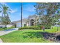 Inviting single-Gathering home with verdant lawn, decorative shrubbery, and convenient two-car garage at 162 Plumoso Loop, Davenport, FL 33897