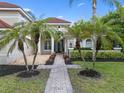 Charming home featuring a tile roof, lush landscaping, and a brick walkway at 1803 Glenbay Ct, Windermere, FL 34786