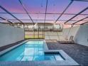 Private screened-in pool with lounge chairs offers the perfect backyard retreat at 2432 Tangier Dr, Kissimmee, FL 34747