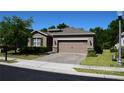 Charming single-story home featuring a well-manicured front yard and a two-car garage at 245 Brunswick Dr, Davenport, FL 33837
