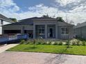 An exterior shot of a single-story home, landscaped yard, and a brick driveway at 2531 Blue Wave Pl, Oviedo, FL 32765