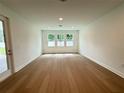 Bright living room with hardwood floors and multiple windows providing natural light at 2531 Blue Wave Pl, Oviedo, FL 32765
