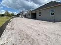 Newly constructed home exterior with a covered patio, showcasing a modern design and spacious outdoor living at 2643 Ravencliffe, Oviedo, FL 32765
