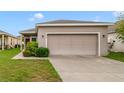 Well-maintained single-story home with a two-car garage and manicured lawn at 2792 Whispering Trails Dr, Winter Haven, FL 33884