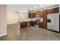Bright kitchen with stainless steel appliances, wood cabinets, and an open layout at 2792 Whispering Trails Dr, Winter Haven, FL 33884
