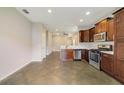 Modern kitchen featuring stainless steel appliances and dark wood cabinetry at 2792 Whispering Trails Dr, Winter Haven, FL 33884