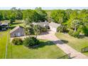 Front yard features mature palms, brick paved driveway and black fencing at 2836 S Stewart St, Kissimmee, FL 34746