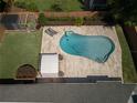 Aerial view of a backyard showcasing a pool, outdoor shed, seating area, landscaping, and wooden perimeter fence at 3029 Peel Ave, Orlando, FL 32806