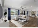Bright living room boasts natural light, modern ceiling fan and stylish furnishings at 3029 Peel Ave, Orlando, FL 32806