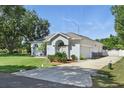 Well-kept one-story home with a side-entry garage, long driveway and landscaping at 392 Bayberry Dr, Polk City, FL 33868