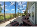 Relaxing screened porch with comfortable seating and view of the backyard at 4687 Nw 35Th Lane Rd, Ocala, FL 34482