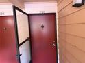 Close-up of unit 206's red front door with security screen at 510 Cranes Way # 206, Altamonte Springs, FL 32701
