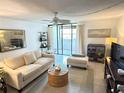 Bright living room with neutral tones and a sliding glass door to balcony at 510 Cranes Way # 206, Altamonte Springs, FL 32701