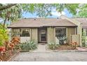 Charming home featuring lush landscaping, mature trees, and a welcoming entrance at 512 Derby Dr, Altamonte Springs, FL 32714