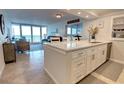 Bright kitchen featuring white cabinetry, stone countertops and stainless steel appliances at 5203 S Atlantic Ave # 416B, New Smyrna Beach, FL 32169