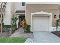 Charming townhouse exterior with an attached garage, neutral colors, and well-manicured landscaping at 558 Pinebranch Cir, Winter Springs, FL 32708