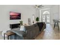 Spacious living room with tile floors, a ceiling fan, and French doors that let in lots of natural light at 581 Hollingshead Loop, Davenport, FL 33896