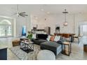 Bright, open living room with tile floors, comfortable seating, and view into dining and kitchen areas at 581 Hollingshead Loop, Davenport, FL 33896