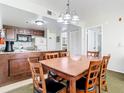 Dining area with wooden table and chairs, adjacent to the open kitchen with ample counter space at 6403 Parc Corniche Dr # 4114, Orlando, FL 32821