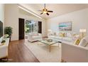 Bright living room features a ceiling fan, modern decor, and sliding glass doors to the outdoor area at 7264 Hawksnest Blvd, Orlando, FL 32835