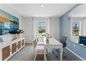 Bright office space with large windows and a sleek white desk, perfect for productivity at 756 Mocking Jay Ln, St Cloud, FL 34771