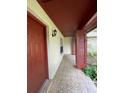 Inviting covered front porch featuring decorative tile flooring and a stylish light fixture at 8129 Granada Blvd, Orlando, FL 32836