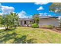 Beautiful single-story home with a well-maintained lawn, mature trees and a covered front entryway at 9143 San Ambrosio, Orlando, FL 32836