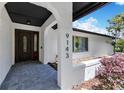 Inviting front porch with textured walls, stylish brick pavers and clear house numbers for easy identification at 9143 San Ambrosio, Orlando, FL 32836