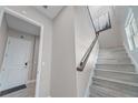 Elegant staircase with wooden railings and modern design elements, enhancing the home's interior at 9255 Doherty Pl, Orlando, FL 32827