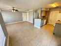 Spacious living room with tile flooring, neutral gray paint, and view of the kitchen area at 1055 S Hiawassee Rd # 2018, Orlando, FL 32835