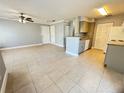 Spacious living room with tile flooring, neutral gray paint, and view of the kitchen area at 1055 S Hiawassee Rd # 2018, Orlando, FL 32835