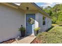 Inviting front door with a colorful wreath, potted plants, and a welcoming entryway at 1118 Brielle Ct, Oviedo, FL 32765