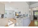 Bright kitchen features white cabinets, stainless appliances, and granite countertops at 1118 Brielle Ct, Oviedo, FL 32765