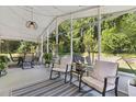 Relaxing screened-in lanai with comfortable seating, string lights, and views of the serene backyard at 1118 Brielle Ct, Oviedo, FL 32765