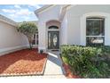 Close up of the front entrance featuring meticulous landscaping, including mulch and manicured bushes at 12213 Bohannon Blvd, Orlando, FL 32824