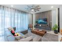 Modern living room with stylish decor, sleek furniture, and bright natural light from large windows at 136 Jetty Way, Davenport, FL 33897