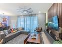 Comfortable living room with large windows, stylish sectional, and unique decor, perfect for relaxing at 136 Jetty Way, Davenport, FL 33897