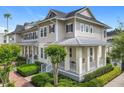 Attractive townhome showcasing a covered front porch, well-maintained landscaping, and a welcoming curb appeal at 1410 Resolute St, Celebration, FL 34747