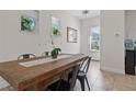 Bright dining room with tile floor, large table, white walls, and lots of light at 14188 Walcott Ave, Orlando, FL 32827
