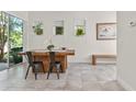 Modern dining space with tile flooring, large window and glass sliding door at 14188 Walcott Ave, Orlando, FL 32827