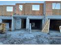 A new construction townhouse featuring a concrete block foundation and wood framing during the building process at 14910 Harvest St, Orlando, FL 32824