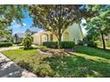 Well-maintained single-Gathering home featuring a lush front lawn and sidewalk access in a peaceful residential neighborhood at 1626 Victoria Gardens Drive, Deland, FL 32724