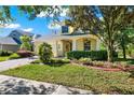 Beautifully landscaped single-Gathering home with a covered front porch and lush green lawn in a well-manicured neighborhood at 1626 Victoria Gardens Drive, Deland, FL 32724
