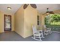 Relaxing covered front porch with ceiling fans and rocking chairs, creating a welcoming outdoor living space at 1626 Victoria Gardens Drive, Deland, FL 32724