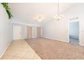 Bright living room featuring tile and carpet floors, ample natural light, and a modern ceiling fan at 1632 Lansfield Ave, Deltona, FL 32738